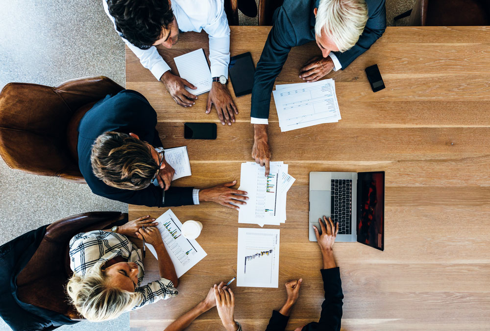 A top down view of people working around a table
